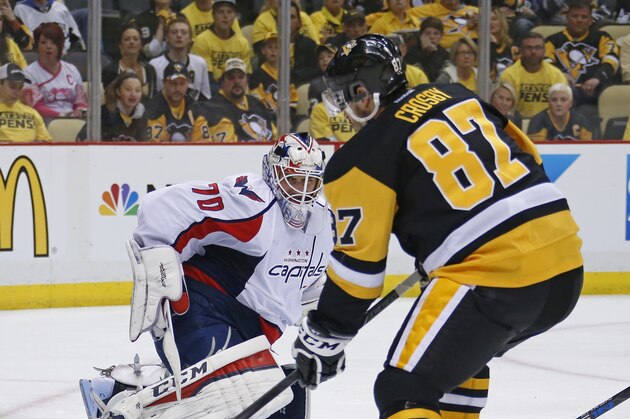 Washington Capitals goalie Braden Holtby (70) slides across the crease as Pittsburgh Penguins center Sidney Crosby (87) tries to get to a loose puck during the second period of Game 3 in an NHL hockey Stanley Cup Eastern Conference semifinals in Pittsburgh, Monday, May 2, 2016. (AP Photo/Gene J. Puskar)
