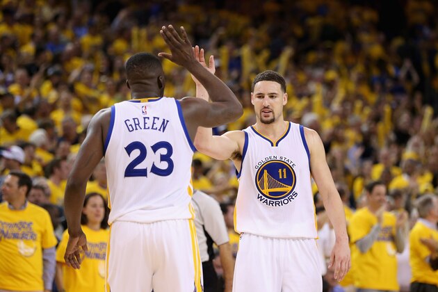 OAKLAND, CA - MAY 03:  Klay Thompson #11 and Draymond Green #23 of the Golden State Warriors celebrate in the final minute of their victory over the Portland Trail Blazers in Game Two of the Western Conference Semifinals during the 2016 NBA Playoffs on May 3, 2016 at Oracle Arena in Oakland, California.  NOTE TO USER: User expressly acknowledges and agrees that, by downloading and or using this photograph, User is consenting to the terms and conditions of the Getty Images License Agreement.  (Photo by Ezra Shaw/Getty Images)