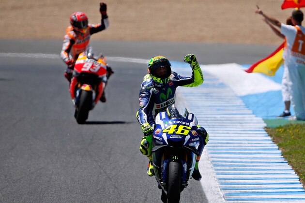 Moto GP rider Valentino Rossi of Italy celebrates after winning the MotoGP race of Spain's Motorcycle Grand Prix at the Jerez race track in Jerez de la Frontera, southern Spain, Sunday, April 24, 2016. At left is championship leader Marc Marquez of Spain who finished third. (AP Photo/Miguel Angel Morenatti)