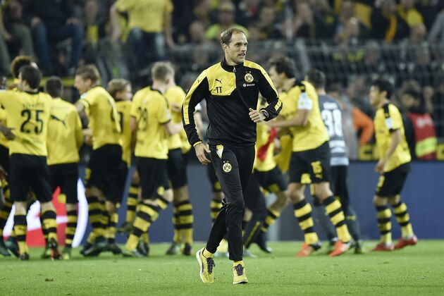 Dortmund head coach Thomas Tuchel runs on the pitch after the German Bundesliga soccer match between Borussia Dortmund and FC Schalke 04 in Dortmund, Germany, Sunday, Nov. 8, 2015. Dortmund defeated Schalke by  3-2. (AP Photo/Martin Meissner)