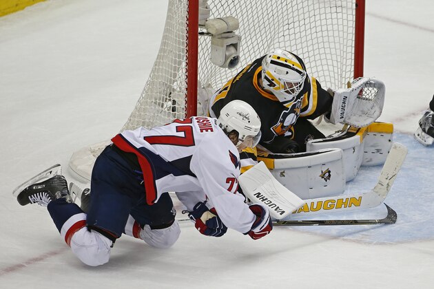 Washington Capitals T.J. Oshie (77) tries to slide the puck past Pittsburgh Penguins goalie Matt Murray (30) during the third period of Game 3 in an NHL hockey Stanley Cup Eastern Conference semifinals in Pittsburgh, Monday, May 2, 2016. (AP Photo/Gene J. Puskar)