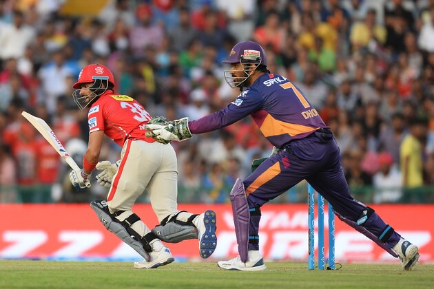 Kings XI Punjab batsman Manan Vohra plays a shot (L) as  Rising Pune Supergiants team captain MS Dhoni looks on  during the 2016 Indian Premier League (IPL) Twenty20 cricket match between Rising Pune Supergiants and Kings XI Punjab at The Punjab Cricket Association Stadium in Mohali on April 17, 2016  ------IMAGE RESTRICTED TO EDITORIAL USE - STRICTLY NO COMMERCIAL USE------ / AFP / SAJJAD HUSSAIN        (Photo credit should read SAJJAD HUSSAIN/AFP/Getty Images)
