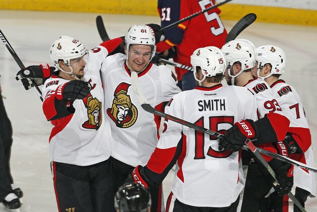 Ottawa Senators forward Mark Stone (61) is congratulated by center Zack Smith (15), defenseman Erik Karlsson (65) and others after scoring a goal to tie the NHL game against the Florida Panthers during the third period Tuesday, Dec. 22, 2015, in Sunrise, Fla. The Panthers defeated the Senators 2-1 in a shootout. (AP Photo/Joel Auerbach)