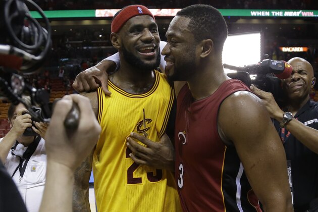 Cleveland Cavaliers forward LeBron James (23) and Miami Heat guard Dwyane Wade talk following an NBA basketball game, Thursday, Dec. 25, 2014, in Miami. The Heat defeated the Cavaliers 101-91. (AP Photo/Lynne Sladky)