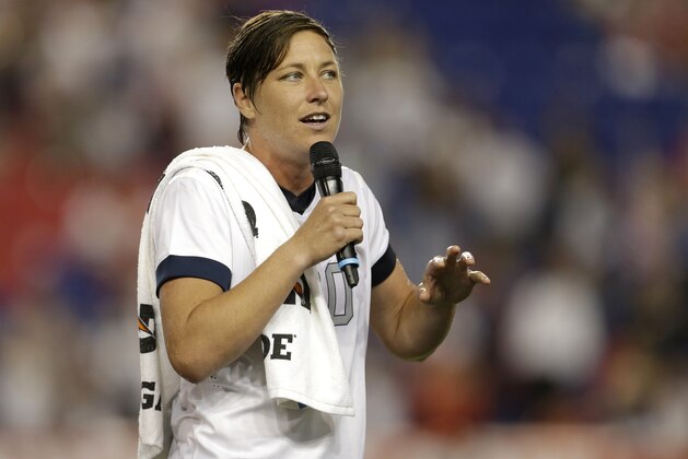 FILE - In this June 20, 2013 file photo, United States' Abby Wambach talks to spectators after an international friendly soccer match in Harrison, N.J. Retired U.S. national team star Abby Wambach is joining ESPN as an analyst and a contributor. Wambach, who is the leading international goal scorer of all time, will cover the European Championships in France and the Rio Olympics in August. But her role will not be limited to soccer: she’ll work across multiple platforms including ESPN Films and shows including “Outside the Lines,” the network said. (AP Photo/Julio Cortez, File)