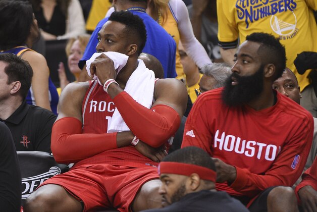 April 16, 2016; Oakland, CA, USA; Houston Rockets guard Patrick Beverley (2, left), center Dwight Howard (12, center), and guard James Harden (13, right) look on during the fourth quarter in game one of the first round of the NBA Playoffs against the Golden State Warriors at Oracle Arena. The Warriors defeated the Rockets 104-78. Mandatory Credit: Kyle Terada-USA TODAY Sports
