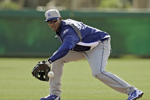 Los Angeles Dodgers shortstop Erisbel Arruebarrena fields ground balls during a baseball spring training workout Friday, March 14, 2014, in Glendale, Ariz. (AP Photo/Mark Duncan)