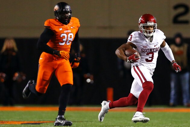 STILLWATER, OK - NOVEMBER 28: Wide receiver Sterling Shepard #3 of the Oklahoma Sooners carries the ball past defensive end Emmanuel Ogbah #38 of the Oklahoma State Cowboys in the second quarter at Boone Pickens Stadium on November 28, 2015 in Stillwater, Oklahoma. (Photo by Tom Pennington/Getty Images)