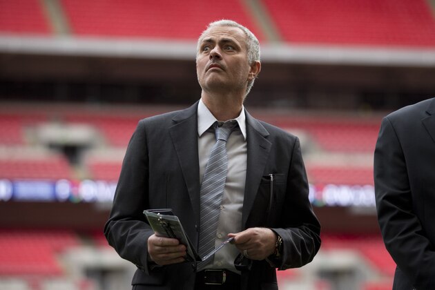 Former Chelsea manager Jose Mourinho attends a group photo session pitchside as a guest of FIFA Presidential Candidate Gianni Infantino after unveiling his 90 day plan that he will implement if he is elected FIFA President, at Wembley Stadium in London, Monday, Feb. 1, 2016.  (AP Photo/Matt Dunham)