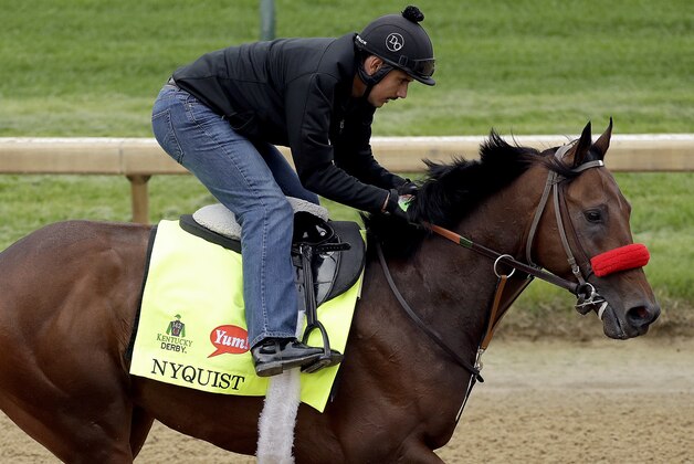 Exercise rider Jonny Garcia rides Kentucky Derby hopeful Nyquist during a workout at Churchill Downs Tuesday, May 3, 2016, in Louisville, Ky. The 142nd running of the Kentucky Derby is scheduled for Saturday, May 7. (AP Photo/Charlie Riedel)