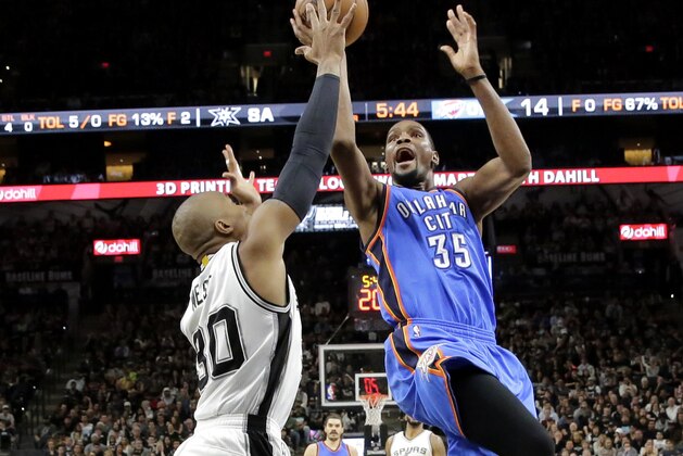 San Antonio Spurs' David West (30) contest a shot attempt by Oklahoma City Thunder's Kevin Durant (35) during the first half in Game 2 of a second-round NBA basketball playoff series, Monday, May 2, 2016, in San Antonio. (AP Photo/Eric Gay)