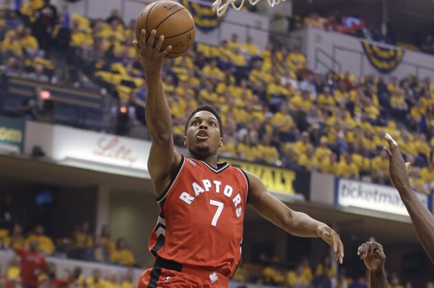 Toronto Raptors' Kyle Lowry (7) puts up a shot against Indiana Pacers' George Hill (3) during the first half of Game 6 of an NBA first-round playoff basketball series Friday, April 29, 2016, in Indianapolis. (AP Photo/Darron Cummings)