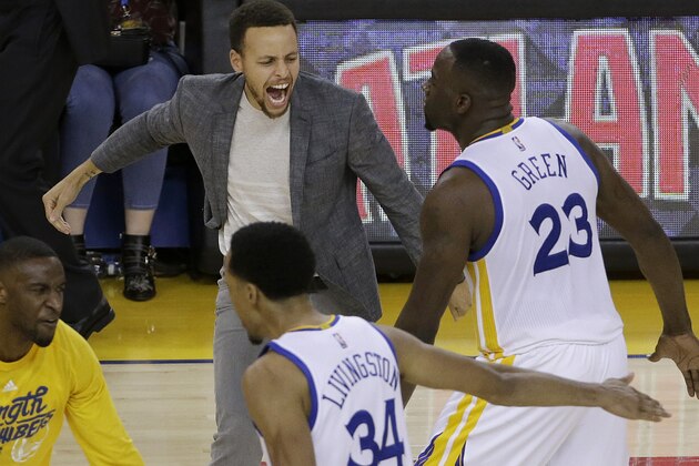 Golden State Warriors guard Stephen Curry, top left, celebrates with guard Ian Clark, bottom left, forward Draymond Green (23) and guard Shaun Livingston (34) during the second half in Game 2 of a second-round NBA basketball playoff series against the Portland Trail Blazers in Oakland, Calif., Tuesday, May 3, 2016. The Warriors won 110-99. (AP Photo/Jeff Chiu)