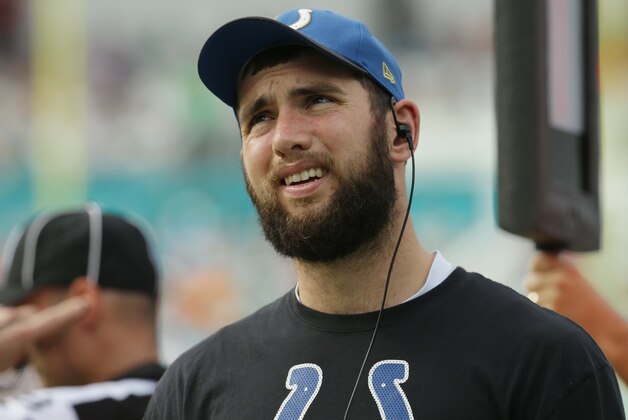 Indianapolis Colts quarterback Andrew Luck looks up from the sidelines during the first half of an NFL football game, Sunday, Dec. 27, 2015, in Miami Gardens, Fla. Luck is not playing due to an injury. (AP Photo/Lynne Sladky)