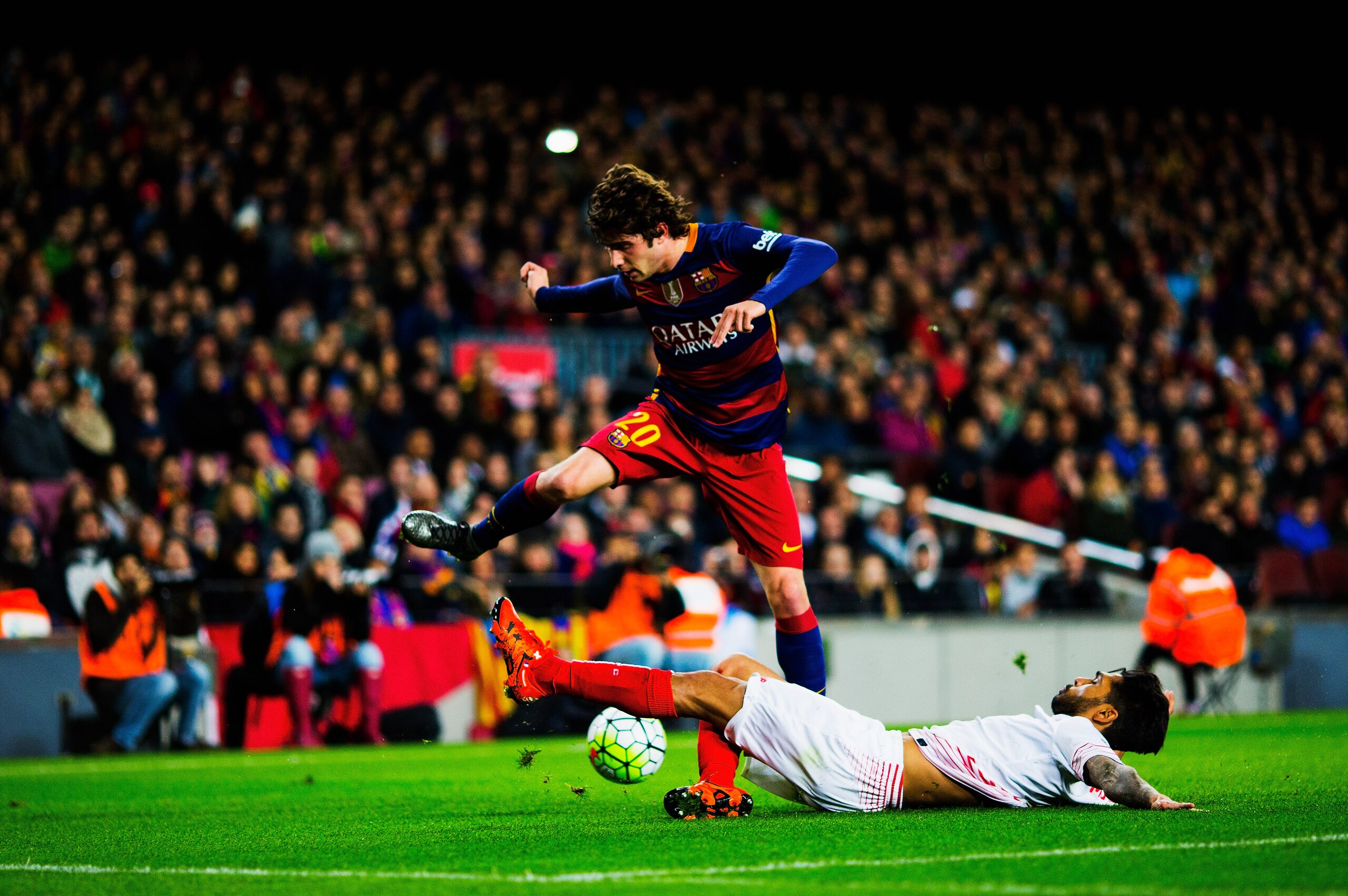 BARCELONA, SPAIN - FEBRUARY 28:  Sergi Roberto of Barcelona attacks as Benoit Tremoulinas of Sevilla slides in  during the La Liga match between FC Barcelona and Sevilla FC at Camp Nou on February 28, 2016 in Barcelona, Spain.  (Photo by Vladimir Rys Photography/Getty Images)
