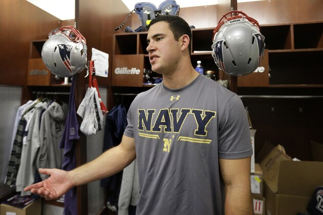 U.S. Navy Ensign Joe Cardona, a long snapper with the New England Patriots, speaks with reporters in the locker room at Gillette Stadium following an NFL football practice, Wednesday, Nov. 11, 2015, in Foxborough, Mass. The Patriots are to play the New York Giants in East Rutherford, N.J., Sunday, Nov. 15, 2015. (AP Photo/Steven Senne)