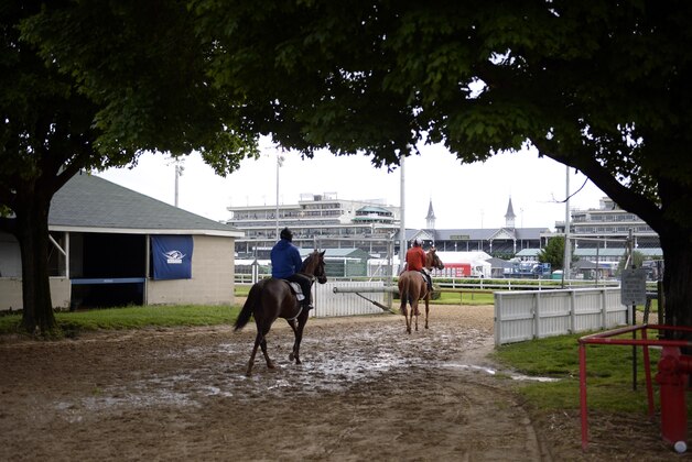 May 5, 2016; Louisville, KY, USA; Exercise riders work their horses during workouts in advance of the 2016 Kentucky Derby at Churchill Downs. Mandatory Credit: Jamie Rhodes-USA TODAY Sports