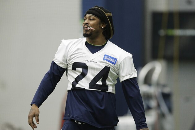 Seattle Seahawks running back Marshawn Lynch holds a candy cane in his mouth as he warms up before NFL football practice, Wednesday, Jan. 6, 2016, in Renton, Wash. Lynch has been recovering since having abdominal surgery last November. (AP Photo/Ted S. Warren)
