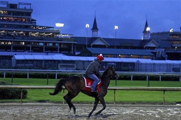 A lone horse and rider gallop over the muddy track at Churchill Downs in Louisville, Ky., before daylight Thursday, May 5, 2016. The 142nd Kentucky Derby is Saturday, May 7. (AP Photo/Garry Jones) A lone horse and rider gallop over the muddy track at Churchill Downs in Louisville, Ky., before daylight Thursday, May 5, 2016. The 142nd Kentucky Derby is Saturday, May 7. (AP Photo/Garry Jones)