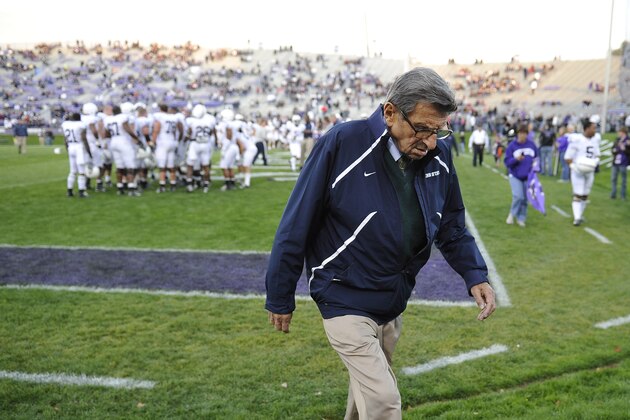 FILE - In this Oct. 22, 2011, file photo, Penn State coach Joe Paterno walks off the field before an NCAA college football game against Northwestern in Evanston, Ill. A proposed settlement, announced Friday, Jan. 16, 2015, by the NCAA, will give Penn State back 112 football team wins that were vacated two years ago in the Jerry Sandusky child molestation scandal.  If approved, the new agreement also would restore former coach Paterno's status as the winningest coach in major college football history with 409 victories.  (AP Photo/Jim Prisching, File)