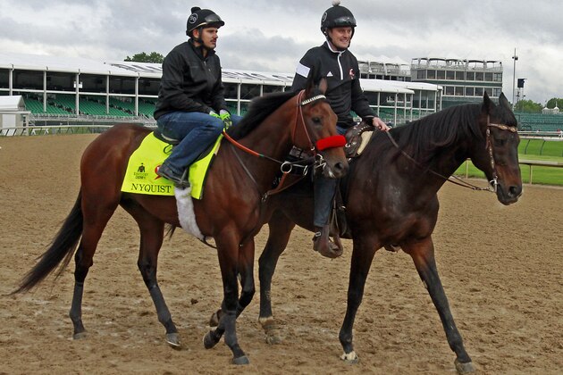Kentucky Derby favorite Nyquist, left, with exercise rider Jonny Garcia aboard, walks out on the track led by assistant trainer Jack Sisterson at Churchill Downs in Louisville, Ky., Thursday, May 5,   2016. The 142nd Kentucky Derby is Saturday, May 7. (AP Photo/Garry Jones)