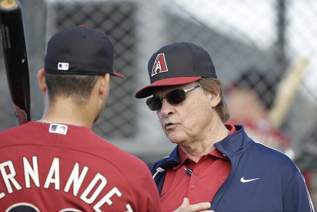 Arizona Diamondbacks chief baseball officer Tony La Russa talks with Oscar Hernandez (23) during spring training baseball practice Sunday, Feb. 22, 2015, in Scottsdale, Ariz. (AP Photo/Darron Cummings)