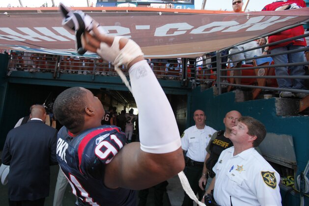 Houston Texans defensive tackle Amobi Okoye throws a glove to a fan as he walk s off the field after the Texans defeated the Dolphins 27-20 in an NFL football game, Sunday, Dec. 27, 2009 in Miami. (AP Photo/Wilfredo Lee) Houston Texans defensive tackle Amobi Okoye throws a glove to a fan as he walk s off the field after the Texans defeated the Dolphins 27-20 in an NFL football game, Sunday, Dec. 27, 2009 in Miami. (AP Photo/Wilfredo Lee)
