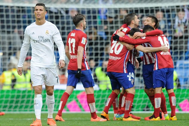MADRID, SPAIN - FEBRUARY 27:  Cristiano Ronaldo of Real Madrid walks away from celebrating Atletico Madrid players after Atletico beat Real 1-0 in the La Liga match between Real Madrid CF and Club Atletico de Madrid at Estadio Santiago Bernabeu on February 27, 2016 in Madrid, Spain.  (Photo by Denis Doyle/Getty Images)
