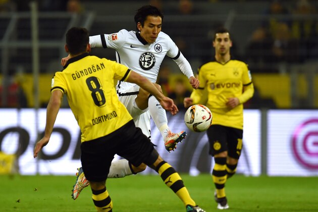 Dortmund's midfielder Ilkay Guendogan (L) and Frankfurt's Japanese midfielder Makoto Hasebe vie for the ball during the German first division Bundesliga football match Borussia Dortmund vs Eintracht Frankfurt in Dortmund, western Germany, on December 13, 2015. AFP PHOTO / PATRIK STOLLARZ

RESTRICTIONS: DURING MATCH TIME: DFL RULES TO LIMIT THE ONLINE USAGE TO 15 PICTURES PER MATCH AND FORBID IMAGE SEQUENCES TO SIMULATE VIDEO. == RESTRICTED TO EDITORIAL USE == FOR FURTHER QUERIES PLEASE CONTACT DFL DIRECTLY AT + 49 69 650050. / AFP / PATRIK STOLLARZ        (Photo credit should read PATRIK STOLLARZ/AFP/Getty Images)