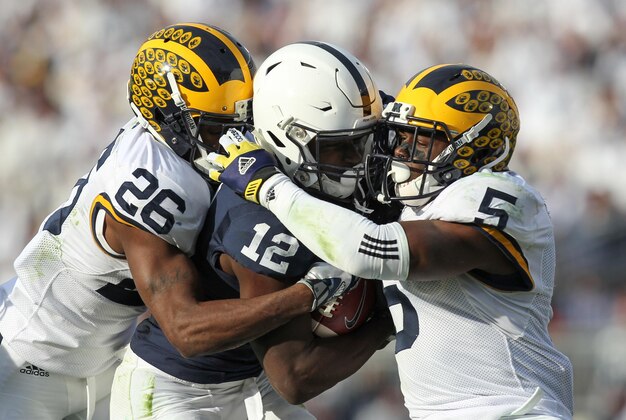 Nov 21, 2015; University Park, PA, USA; Penn State Nittany Lions wide receiver Chris Godwin (12) runs with the ball as Michigan Wolverines cornerback Jourdan Lewis (26) and safety Jabrill Peppers (5) attempt to tackle during the third quarter at Beaver Stadium. Michigan defeated Penn State 28-16. Mandatory Credit: Matthew O'Haren-USA TODAY Sports