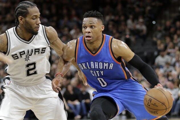 San Antonio Spurs' Kawhi Leonard (2) defends against a drive to the basket by Oklahoma City Thunder's Russell Westbrook (0) during the first half in Game 2 of a second-round NBA basketball playoff series, Monday, May 2, 2016, in San Antonio. (AP Photo/Eric Gay)