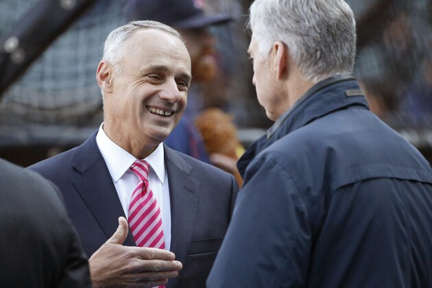 Major League Baseball commissioner Rob Manfred, left, talks with Boston Red Sox president of baseball operations Dave Dombrowski before a baseball game between the Chicago White Sox and the Red Sox Thursday, May 5, 2016, in Chicago. (AP Photo/Charles Rex Arbogast)