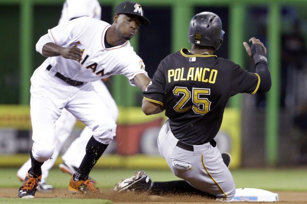 Miami Marlins second baseman Dee Gordon, left, tags out Pittsburgh Pirates' Gregory Polanco (25) after Polanco tried to steal the base during the first inning of a baseball game, Thursday, Aug. 27, 2015, in Miami. (AP Photo/Wilfredo Lee)