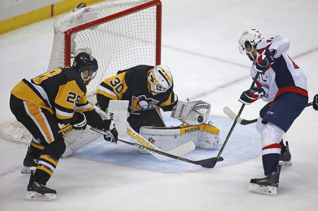 Pittsburgh Penguins goalie Matt Murray (30) makes a save on Washington Capitals Justin Williams (14) as Ian Cole (28) moves in to help during the first period of Game 4 in an NHL hockey Stanley Cup Eastern Conference semifinals in Pittsburgh, Wednesday, May 4, 2016. (AP Photo/Gene J. Puskar)