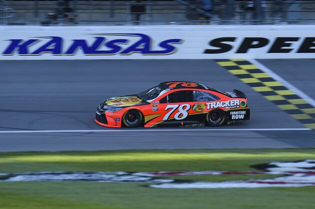 Martin Truex Jr. (78) turned in the fastest time during NASCAR Sprint Cup Series qualifying at Kansas Speedway to win the pole for the Go Bowling 400 auto race in Kansas City, Kan., Friday, May 6, 2016. (AP Photo/Reed Hoffmann)