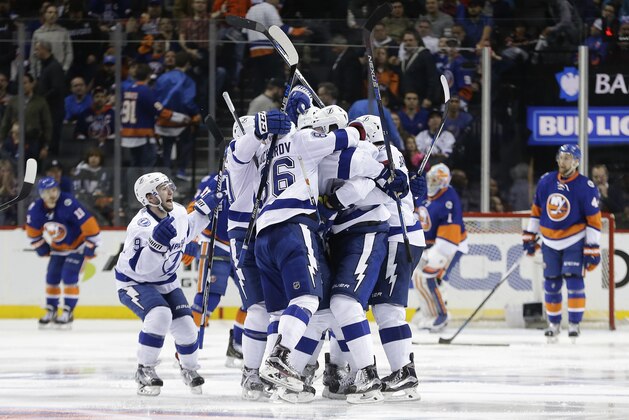 The Tampa Bay Lightning celebrate the game winning goal by defenseman Jason Garrison (5) against the New York Islanders during the overtime period of Game 4 of the NHL hockey Stanley Cup Eastern Conference semifinals, Friday, May 6, 2016, in New York. The Lightning won 2-1. (AP Photo/Frank Franklin II) The Tampa Bay Lightning celebrate the game winning goal by defenseman Jason Garrison (5) against the New York Islanders during the overtime period of Game 4 of the NHL hockey Stanley Cup Eastern Conference semifinals, Friday, May 6, 2016, in New York. The Lightning won 2-1. (AP Photo/Frank Franklin II)
