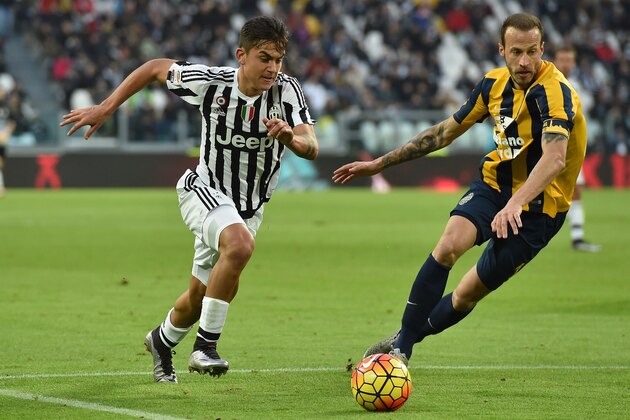 TURIN, ITALY - JANUARY 06:  Paulo Dybala (L) of Juventus FC in action against Evangelos Moras of Hellas Verona FC during the Serie A match between Juventus FC and Hellas Verona FC at Juventus Arena on January 6, 2016 in Turin, Italy.  (Photo by Valerio Pennicino/Getty Images)