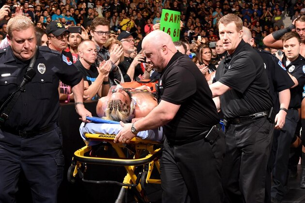 Enzo Amore being taken out of the arena by EMTs at Payback.