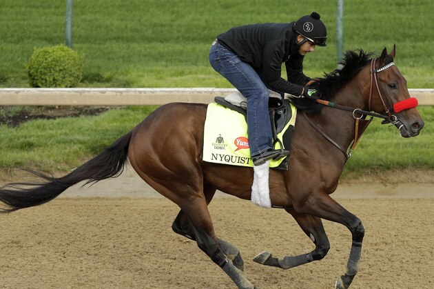 Exercise rider Jonny Garcia rides Kentucky Derby hopeful Nyquist during a workout at Churchill Downs Thursday, May 5, 2016, in Louisville, Ky. The 142nd running of the Kentucky Derby is scheduled for Saturday, May 7. (AP Photo/Charlie Riedel)