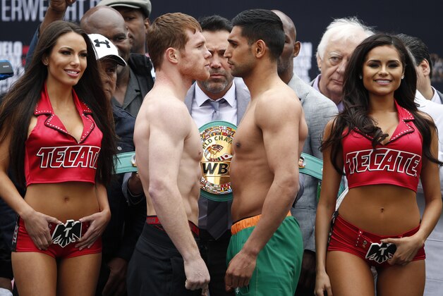 Canelo Alvarez, center left, and Amir Khan, center right, pose during a weigh-in Friday, May 6, 2016, in Las Vegas. The two are scheduled to fight in a middleweight championship bout Saturday in Las Vegas. (AP Photo/John Locher)
