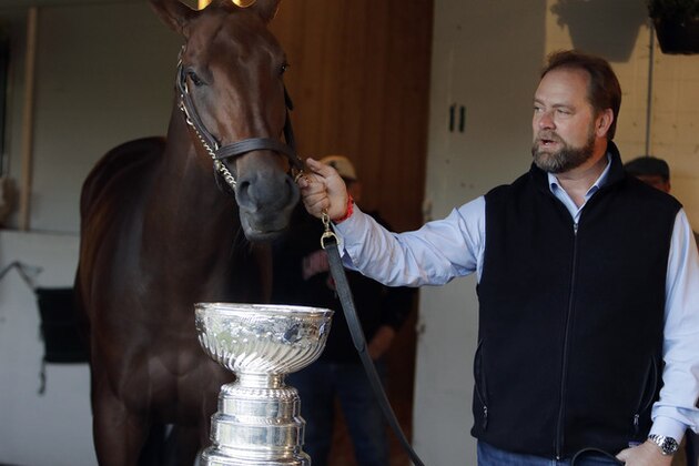 Kentucky Derby entrant Nyquist and trainer Doug O'Neill pose with the Stanley Cup before the 142nd running of the Kentucky Derby horse race at Churchill Downs Saturday, May 7, 2016, in Louisville, Ky. (AP Photo/Garry Jones)