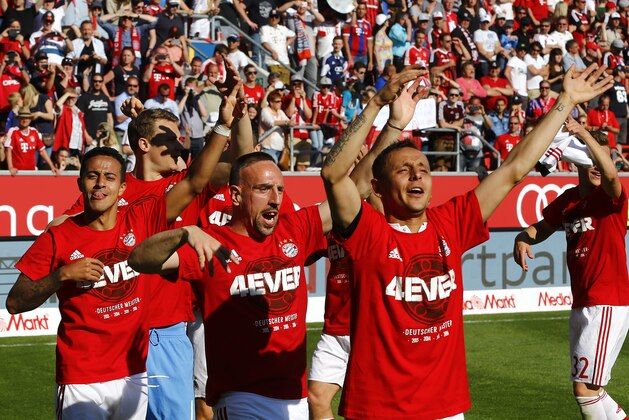 Bayern's Rafinha, from right, Franck Ribery, and Thiago celebrate after winning the 26th Bundesliga title at the German Bundesliga soccer match between FC Ingolstadt and FC Bayern Munich in Ingolstadt, Germany, Saturday, May 7, 2016. (AP Photo/Matthias Schrader)