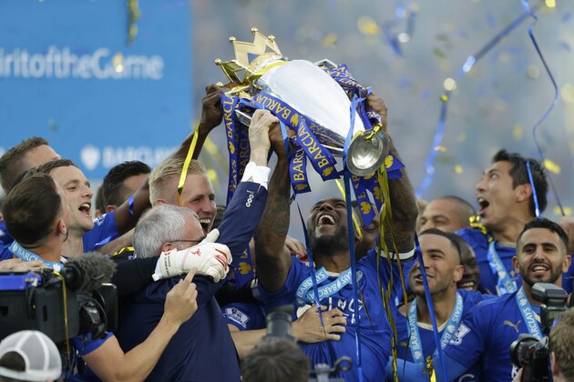 Leicester’s Wes Morgan lifts the trophy as Leicester City celebrate becoming the English Premier League soccer champions at King Power stadium in Leicester, England, Saturday, May 7, 2016.(AP Photo/Matt Dunham)