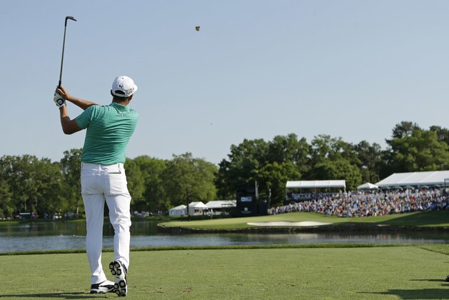 Rickie Fowler watches his tee shot on the 17th hole during the third round of the Wells Fargo Championship golf tournament at Quail Hollow Club in Charlotte, N.C., Saturday, May 7, 2016. (AP Photo/Chuck Burton)