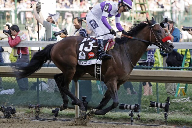 Mario Gutierrez celebrates after riding Nyquist to victory during the 142nd running of the Kentucky Derby horse race at Churchill Downs Saturday, May 7, 2016, in Louisville, Ky. (AP Photo/Garry Jones)