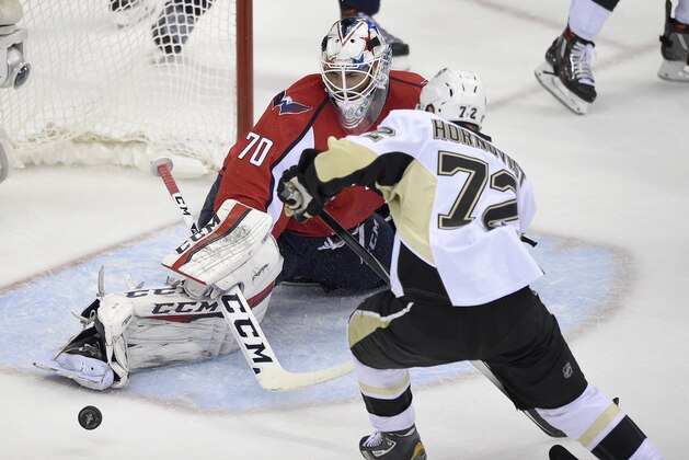 Washington Capitals goalie Braden Holtby (70) stretches for the puck during the second period of Game 5 in an NHL hockey Stanley Cup Eastern Conference semifinals against Pittsburgh Penguins right wing Patric Hornqvist (72), of Sweden, Saturday, May 7, 2016, in Washington. (AP Photo/Nick Wass)