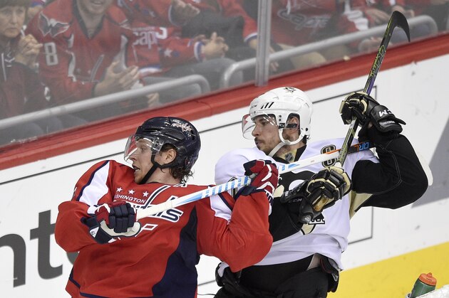Pittsburgh Penguins center Sidney Crosby, right, holds onto the stick of Washington Capitals center Nicklas Backstrom, left, of Sweden, during the third period of Game 5 in an NHL hockey Stanley Cup Eastern Conference semifinals, Saturday, May 7, 2016, in Washington. The Capitals won 3-1. (AP Photo/Nick Wass)