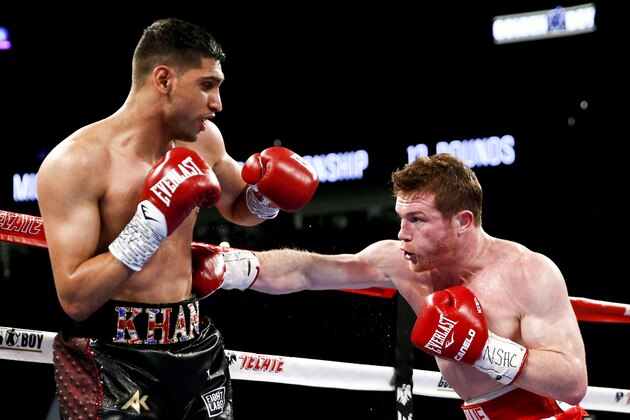 Canelo Alvarez, right, hits Amir Khan during their WBC middleweight title fight Saturday, May 7, 2016, in Las Vegas. (AP Photo/John Locher) Canelo Alvarez, right, hits Amir Khan during their WBC middleweight title fight Saturday, May 7, 2016, in Las Vegas. (AP Photo/John Locher)
