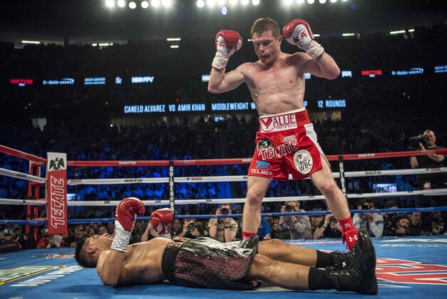 May 7, 2016; Las Vegas, NV, USA; Canelo Alvarez (red shorts) knocks out Amir Khan (maroon shorts) during their middleweight boxing title fight at T-Mobile Arena. Mandatory Credit: Joshua Dahl-USA TODAY Sports