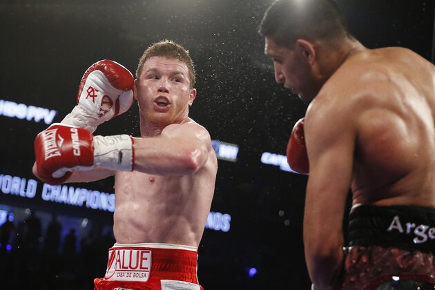 Canelo Alvarez, left, fights Amir Khan during their WBC middleweight title fight Saturday, May 7, 2016, in Las Vegas. (AP Photo/John Locher)